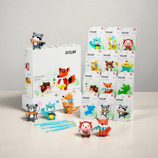 OLiHUG Animal Paradise Air Dry Clay Kit with 12 animal figurine boxes, sculpting tools, and bright packaging displayed on a wooden table. A perfect Montessori-inspired creative activity and educational gift for kids who love art and screen-free play. Promotes imagination, fine motor skills, and joyful learning through hands-on crafting.