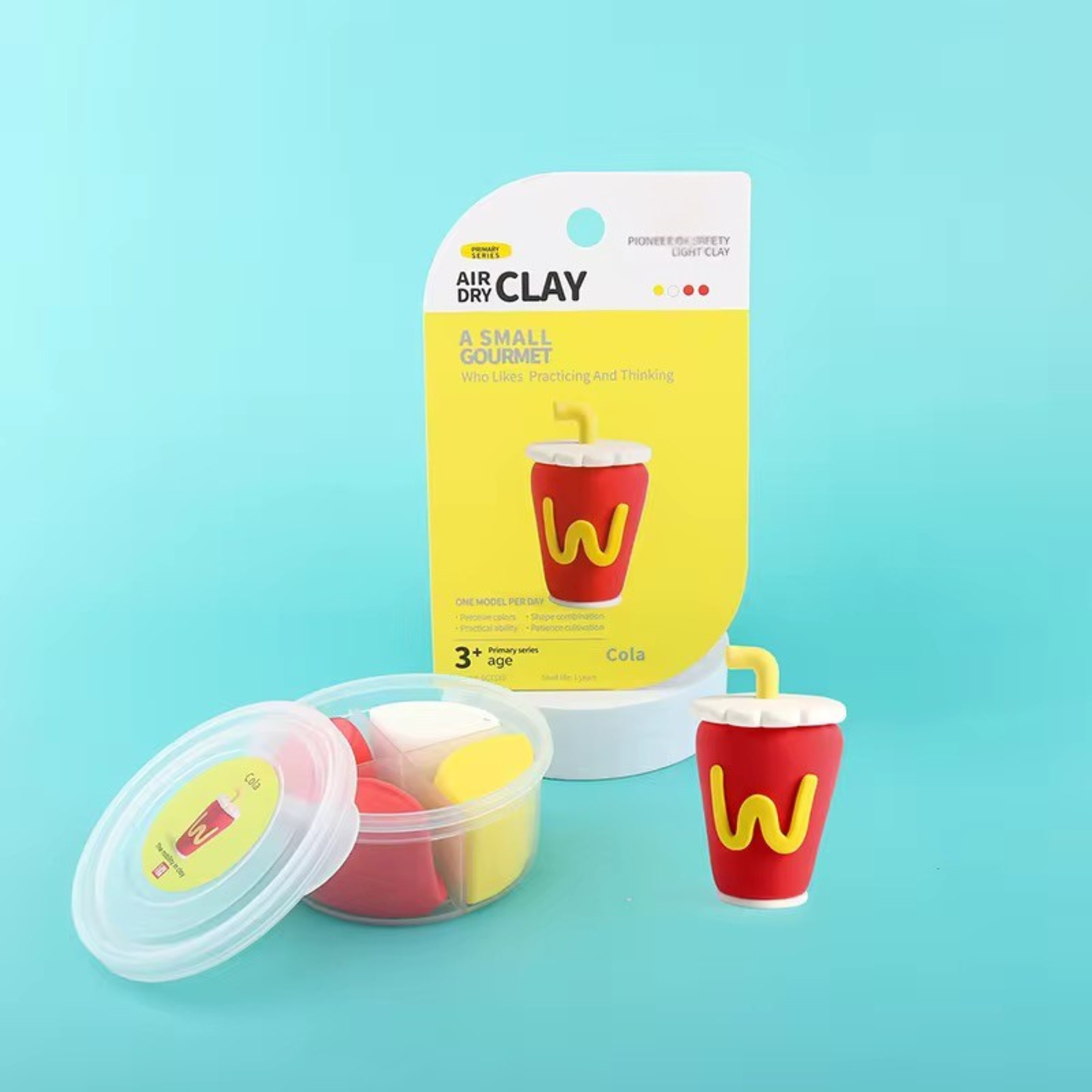 Close-up of OLIHUG fast food clay kit packaging with visible clay tubs in red, yellow, and brown. High-quality plant-based air dry clay for safe sensory play. Each container includes materials to create one mini food figure. Great for gifting or educational use.
