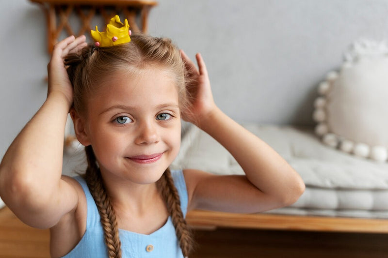 A happy little girl wearing a handmade clay crown created with an OLIHUG air dry clay kit. This heartwarming photo reflects creativity, mindfulness, and the joy of screen-free play. OLIHUG kits are designed for kids and adults to connect through art, relax, and create beautiful memories together — inspiring calm, imagination, and family bonding.