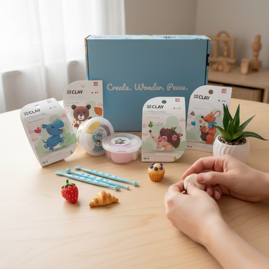 Montessori air dry clay kit for kids and adults, shown in real use with hands shaping colorful clay food figures on a wooden table. Creative DIY activity set designed for screen-free play, fine motor skill development, family bonding, and calm creative time at home. Ideal for children, parents, and couples looking for mindful craft activities.