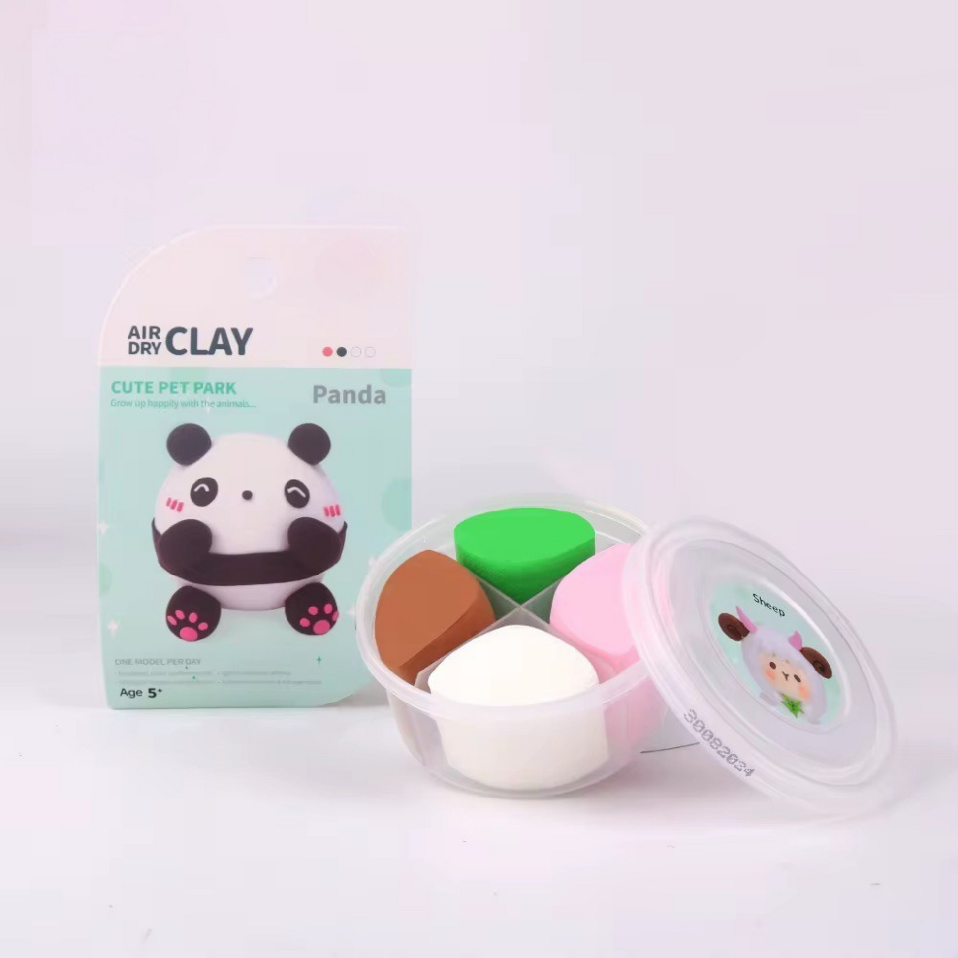 Panda sculpture from OLIHUG air dry clay kit shown beside included color tubs. Illustrates soft clay texture and finished figure. Perfect for toddler-safe creative craft play.