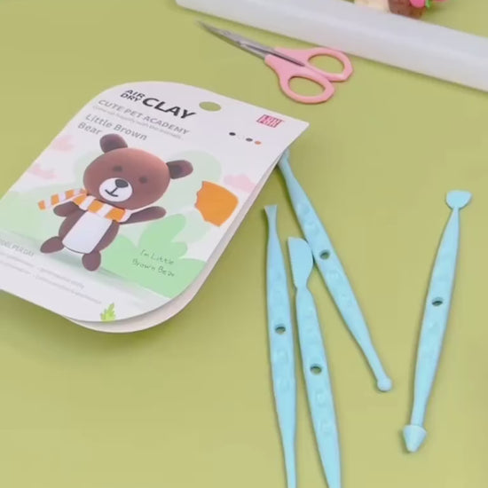 Set of safe blue sculpting tools and creative guide from the OLiHUG Animal Paradise Air Dry Clay Kit. Montessori-inspired crafting activity that encourages kids to explore creativity, sensory play, and focus while staying screen-free. A perfect creative gift for children and families who love art