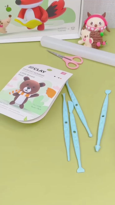 Set of safe blue sculpting tools and creative guide from the OLiHUG Animal Paradise Air Dry Clay Kit. Montessori-inspired crafting activity that encourages kids to explore creativity, sensory play, and focus while staying screen-free. A perfect creative gift for children and families who love art